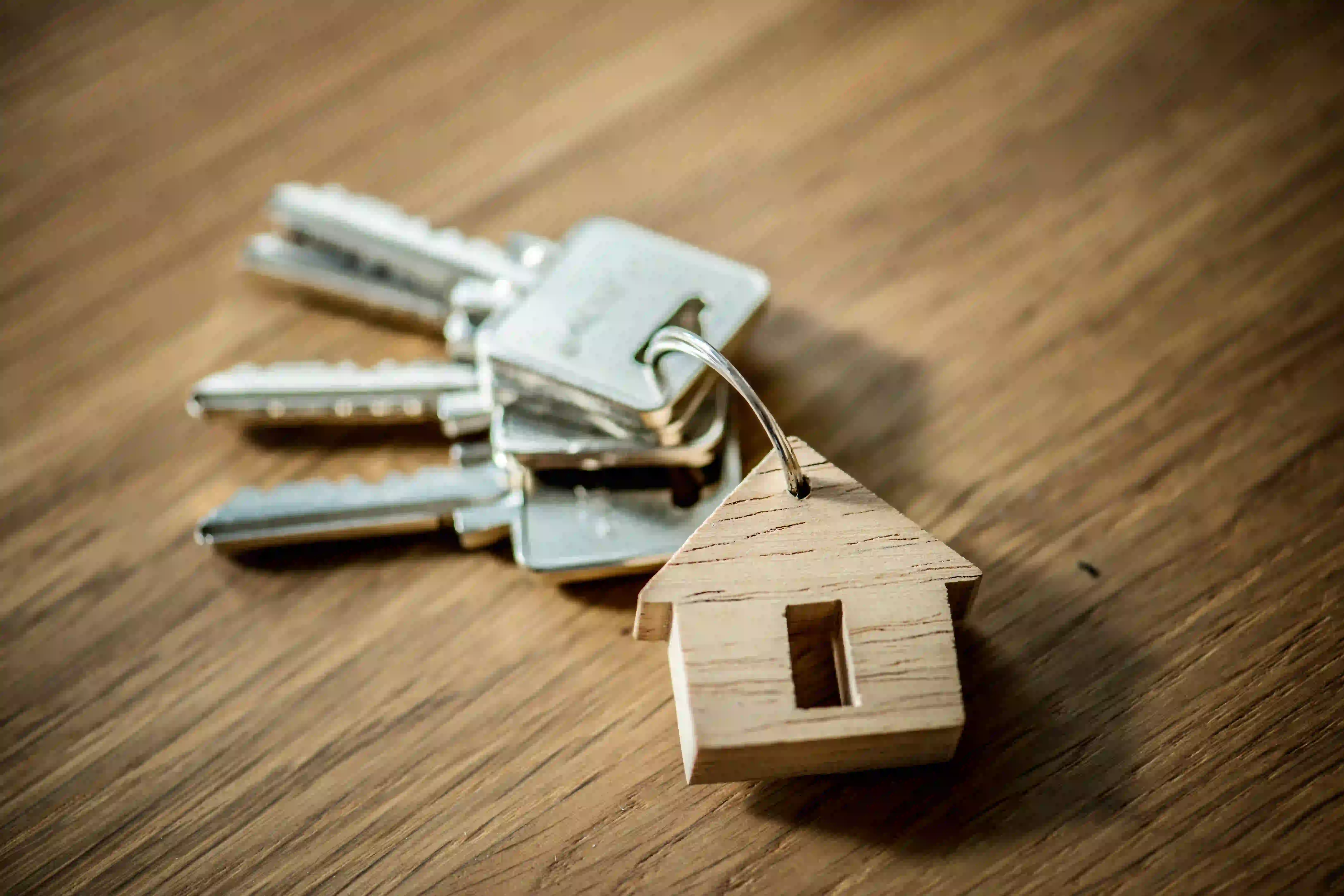 House-shaped keychain and keys representing real estate agent paid social media strategy.