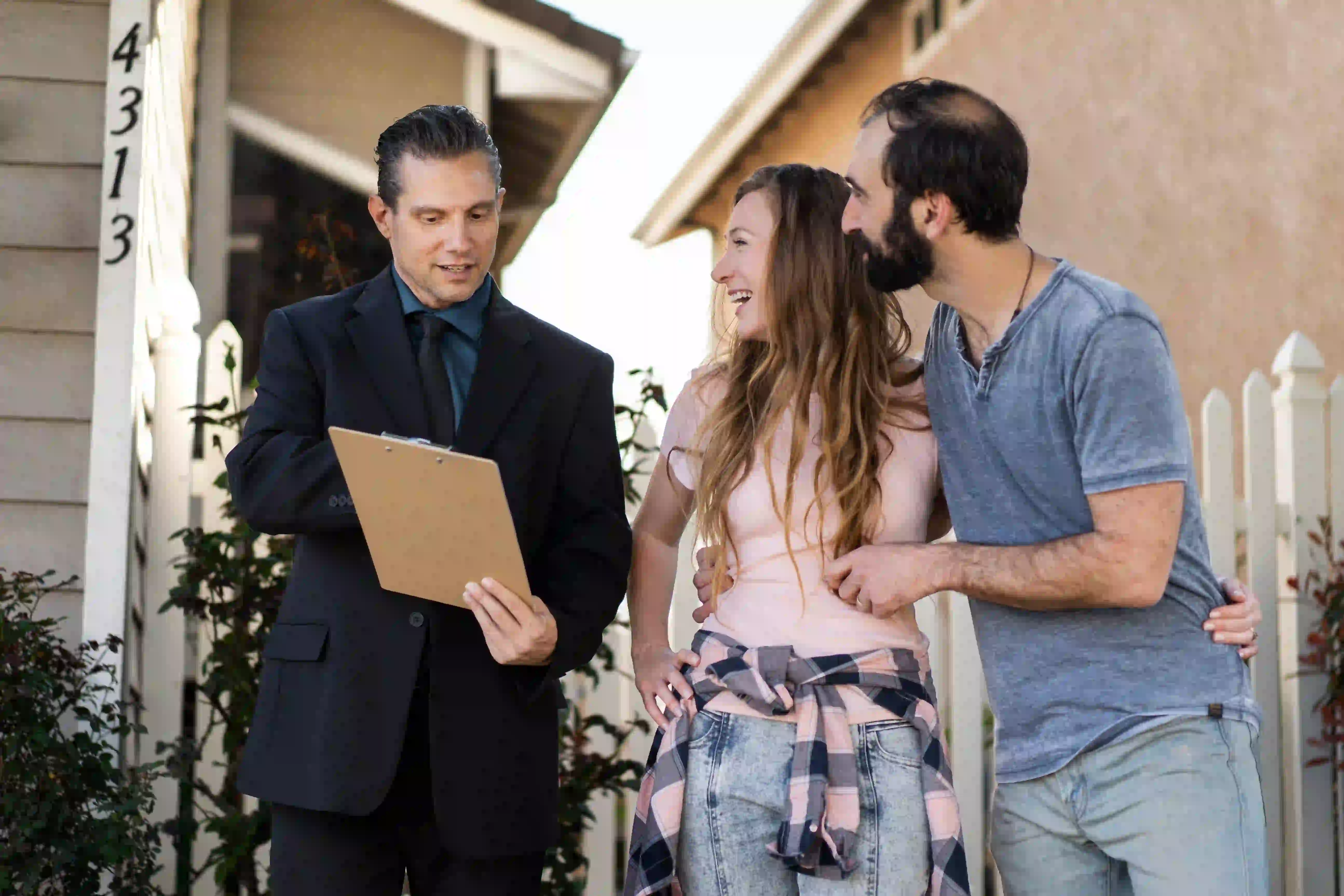 Agent advises homebuyers using real estate neighborhood guide marketing materials.