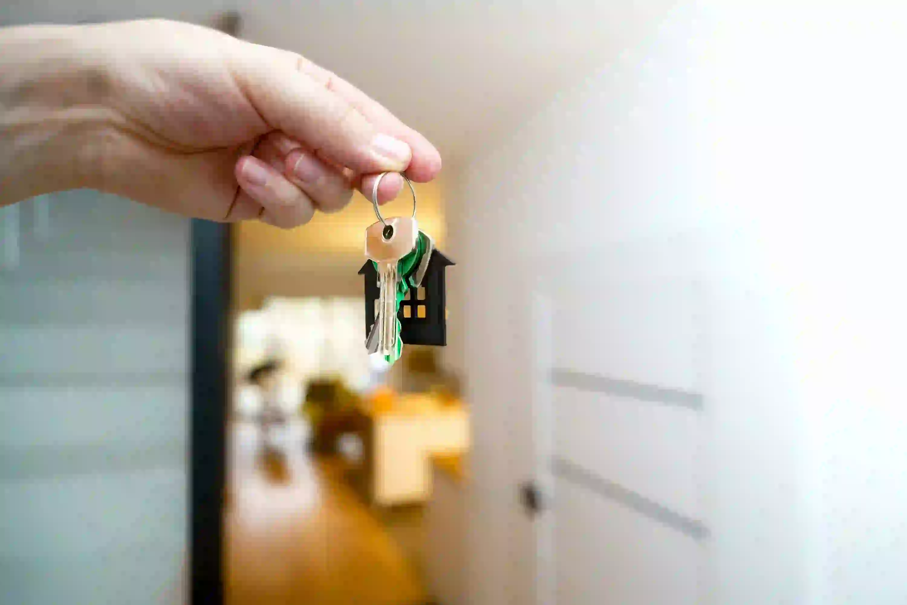 Hand holding house keys illustrating real estate seller lead nurture email sequence tips.