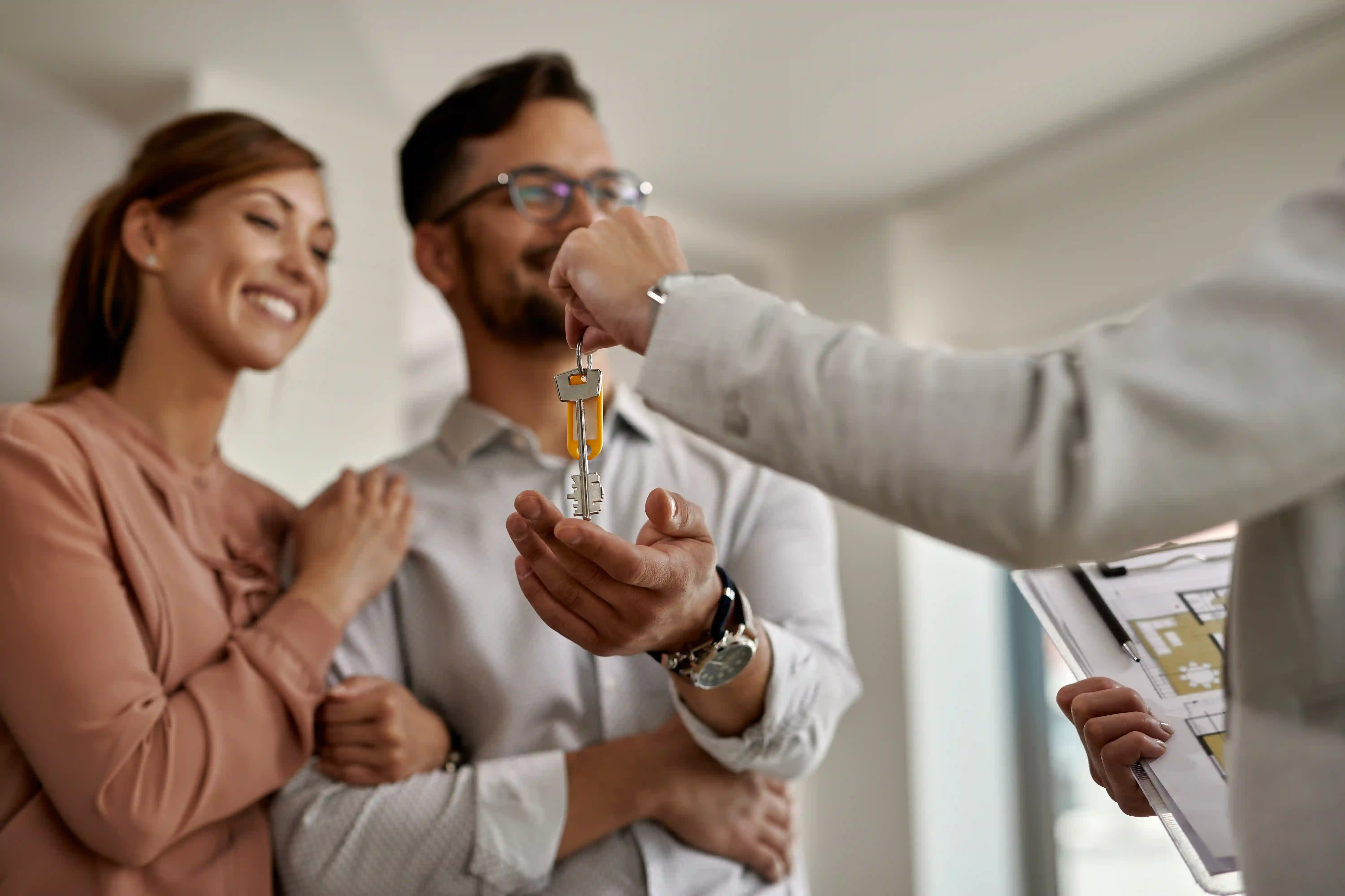 Couple receiving keys, illustrating how to build a real estate personal brand with video.
