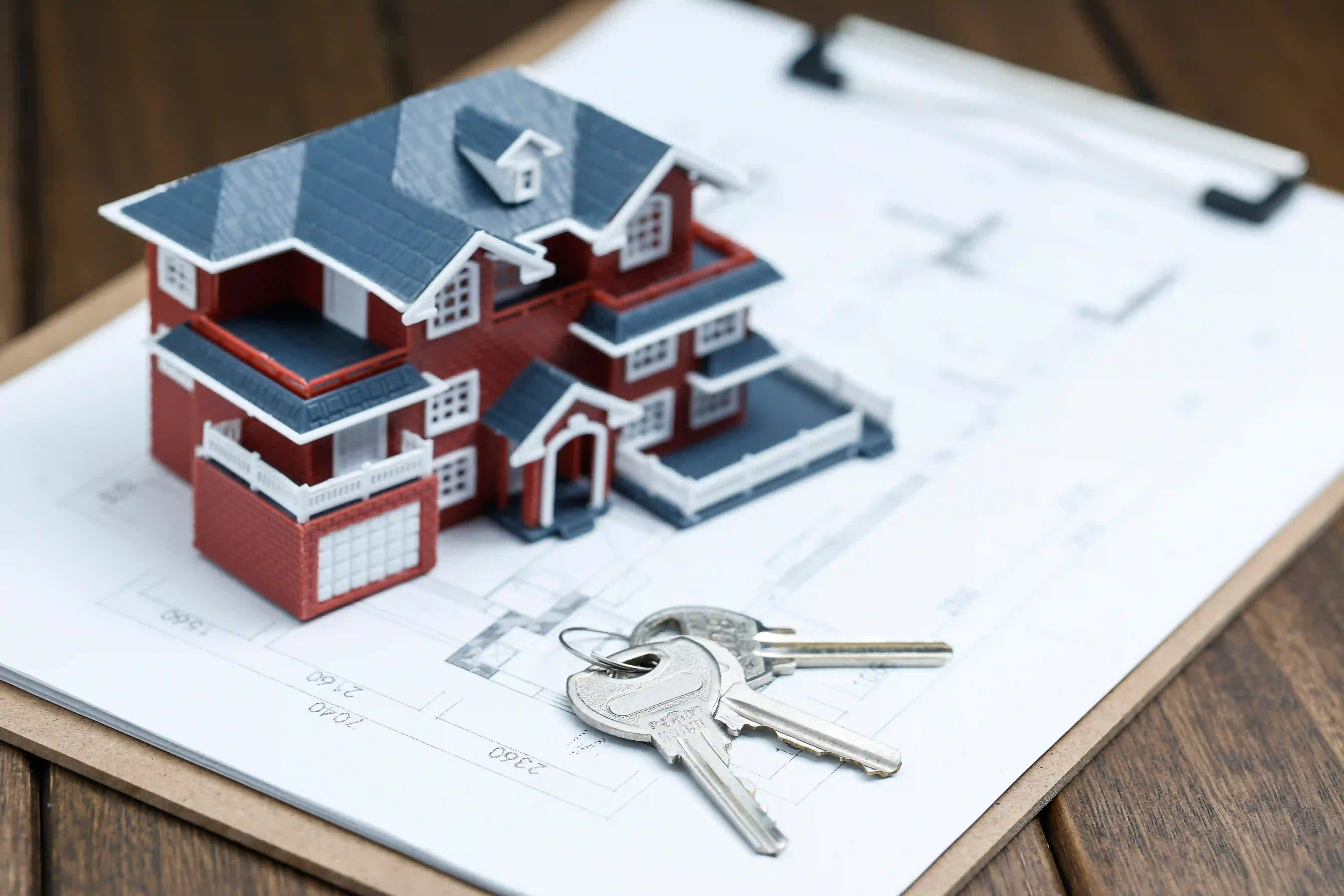 House model and keys illustrating how to become the go-to agent in your neighborhood.